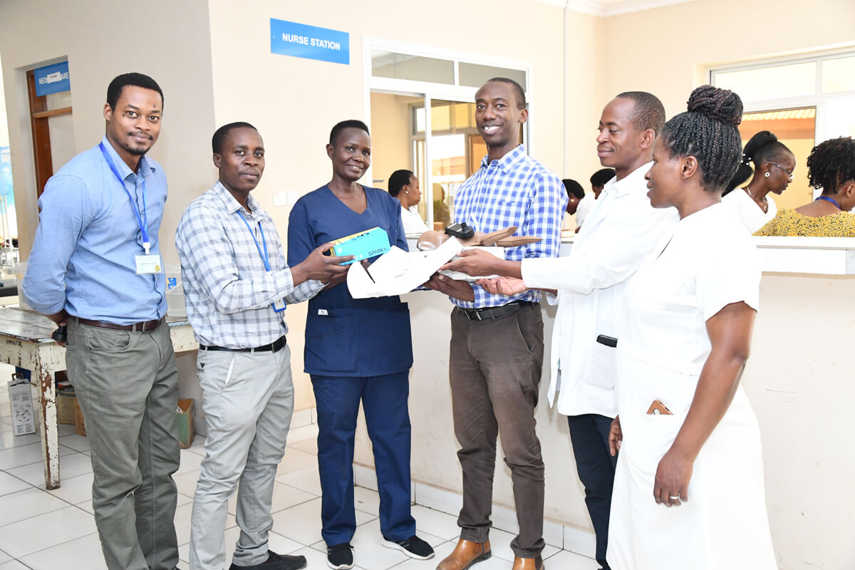 Group around nurses station holding training tools